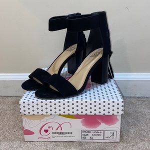 Black sandal heels with zipper in the back